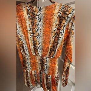 Rotate Mini Dress, silky kinda sparkly, stretches, has padded shoulders